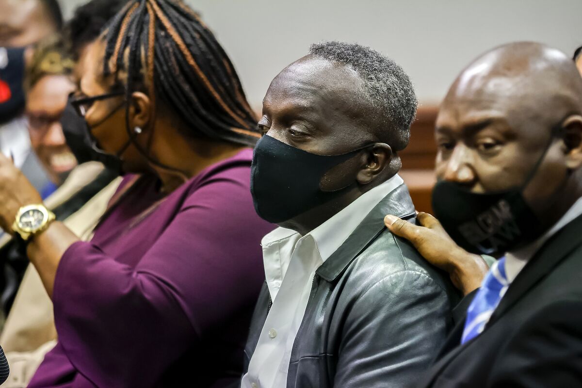 Ahmaud Arbery's father Marcus Arbery sits in court with other family members during the sentencing of his son's killers. 