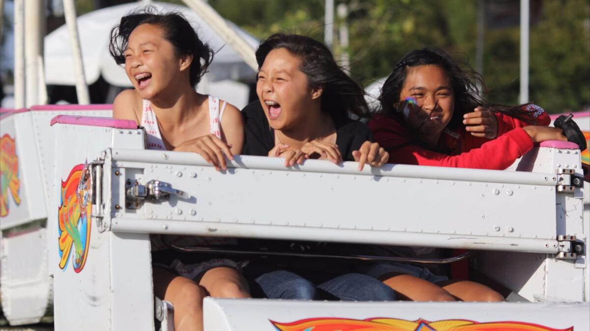 Carnival riders enjoy Fountain Valley's Summerfest in 2013. This year's event runs Thursday through Sunday.