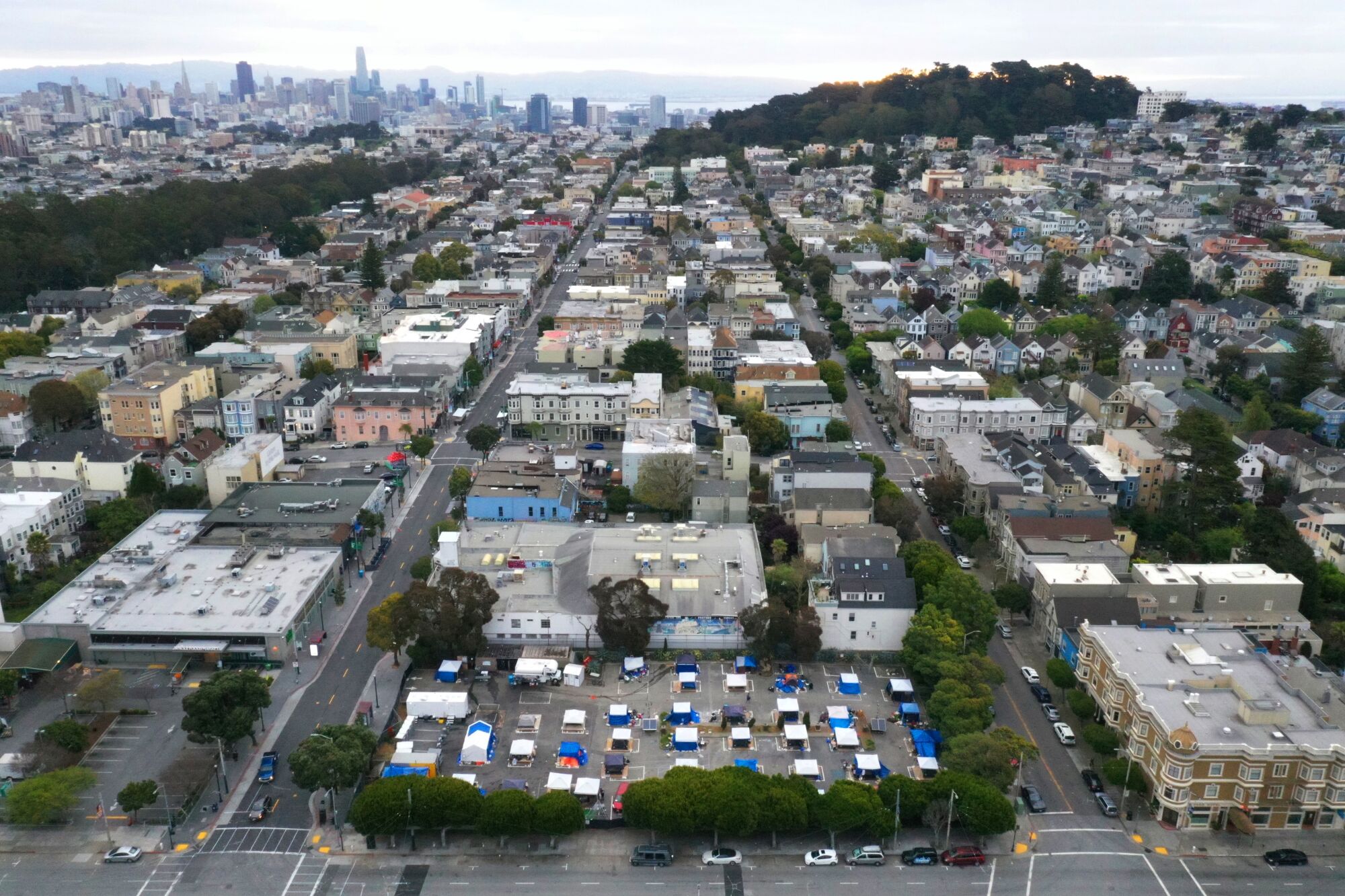 An aerial view of San Francisco shows a block with tents