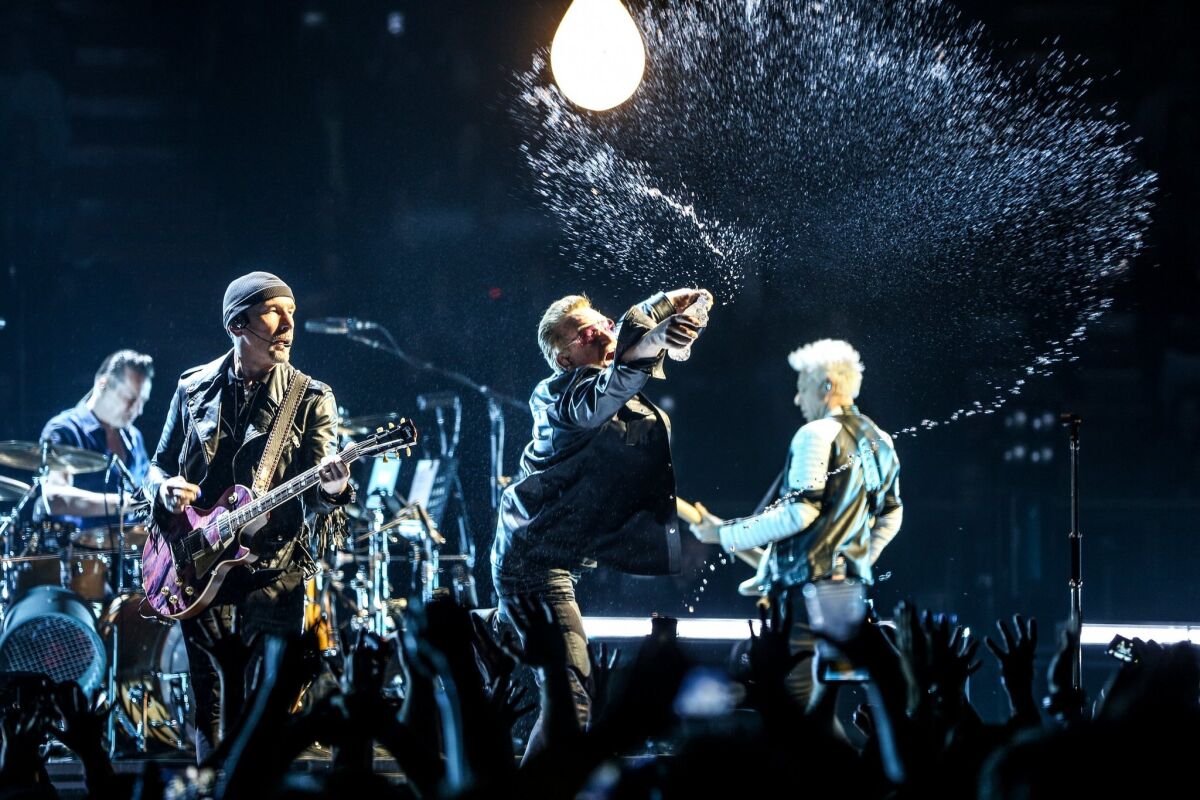Larry Mullen Jr., from left, the Edge, Bono and Adam Clayton of U2 shown performing at the Innocence + Experience tour at the Forum in Inglewood in May. The Edge and Clayton made a surprise appearance Wednesday in New York with U2 tribute band Unforgettable Fire.