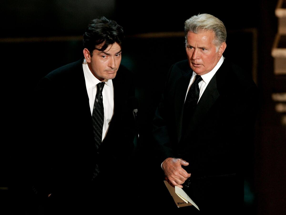 Charlie Sheen, left, and his father, Martin Sheen, present during the 58th Primetime Emmy Awards in August 2006. The younger Sheen announced this week that he is HIV-positive.