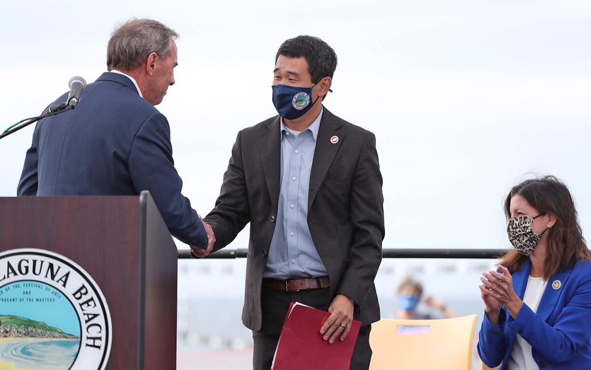 Mayor Bob Whalen, greets state Sen. Dave Min during a press conference in Laguna Beach.