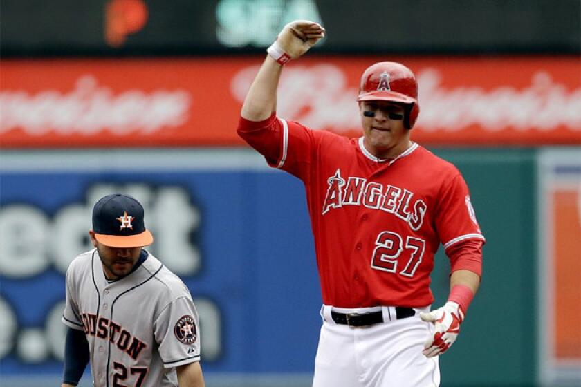 The Angels' Mike Trout celebrates after heading into second base with a double in the first inning.