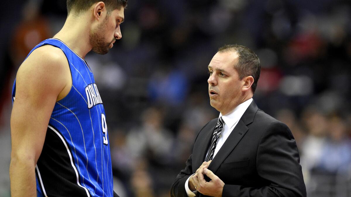Orlando Magic Coach Frank Vogel, right, talks to center Nikola Vucevic during a game in early December.