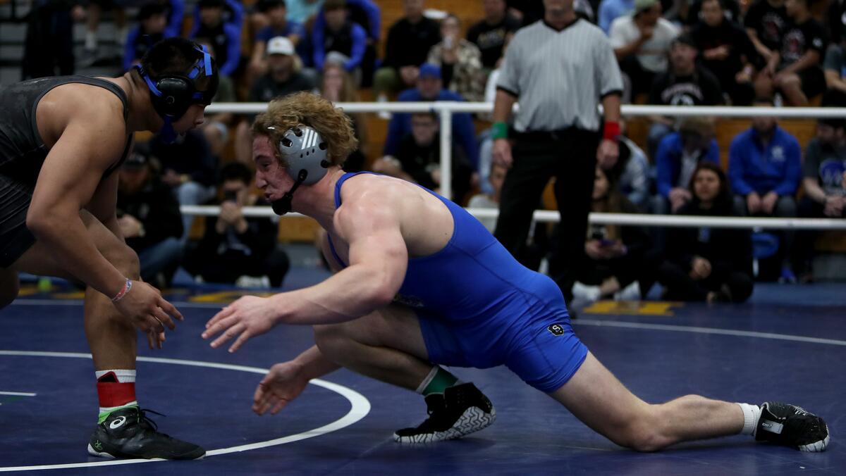 Fountain Valley's Ryland Whitworth, right, wrestles Gilroy's Cody Merrill in the 195-pound championship final.