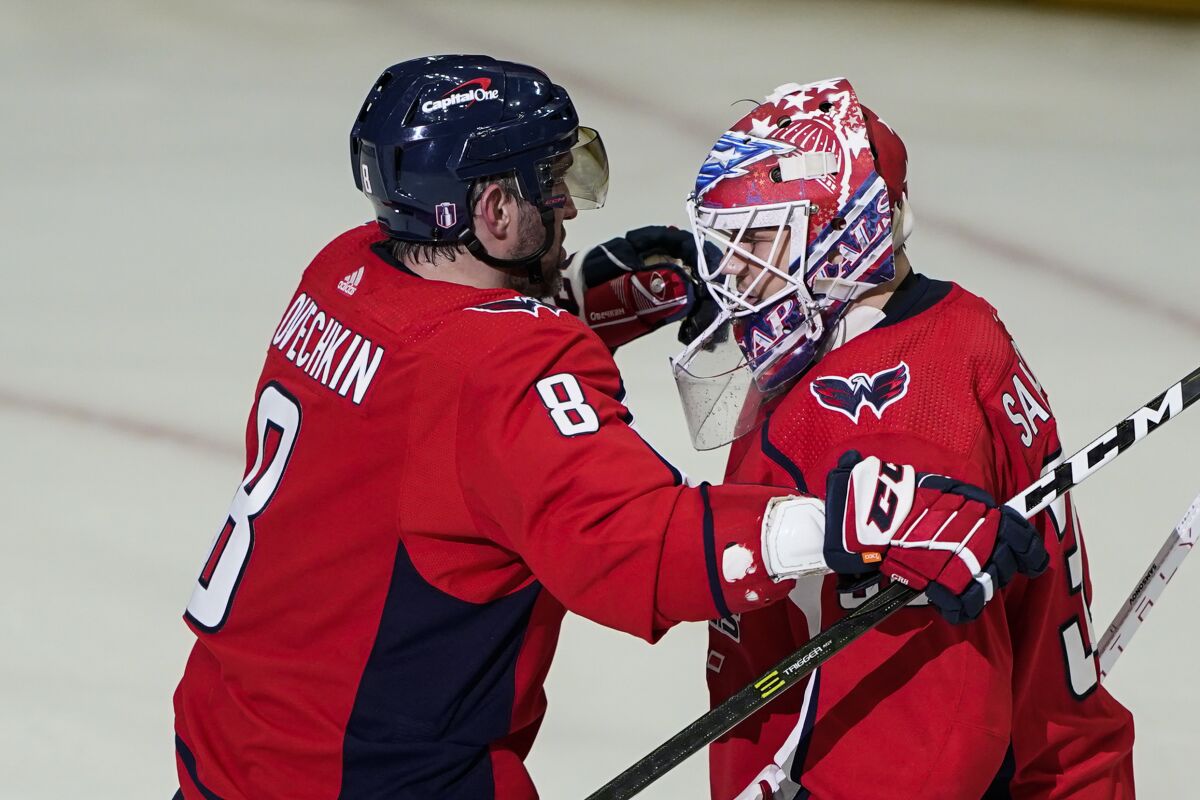 Washington Capitals left wing Alex Ovechkin and goaltender Ilya Samsonov embrace after Game 3 in the first-round of the NHL Stanley Cup hockey playoffs, Saturday, May 7, 2022, in Washington. The Capitals won 6-1. (AP Photo/Alex Brandon)