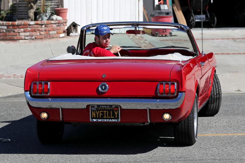 Daniel Morgan backs up his aunts 1965' Mustang 298 convertible, a car his grandpa brought out west as a gift to his aunt and he now keeps care of in Costa Mesa. The car will be part of "Cruisin for a Cure" Classic Car Show at the OC Fair and Events Center this Saturday.