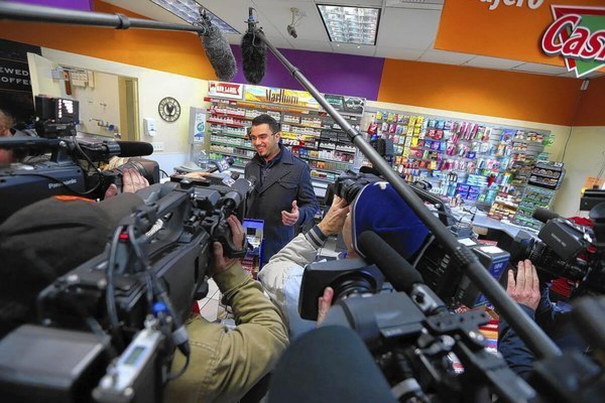 Parmeet Singh, son of Dixon Landing Chevron store owner Kulwinder Singh, speaks to reporters at the store in Milpitas, Calif., on Thursday. According to California lottery officials, the store sold the lone winning ticket for a $425-million Powerball jackpot but there was no immediate word on who may have won one of the largest lottery jackpots in U.S. history.