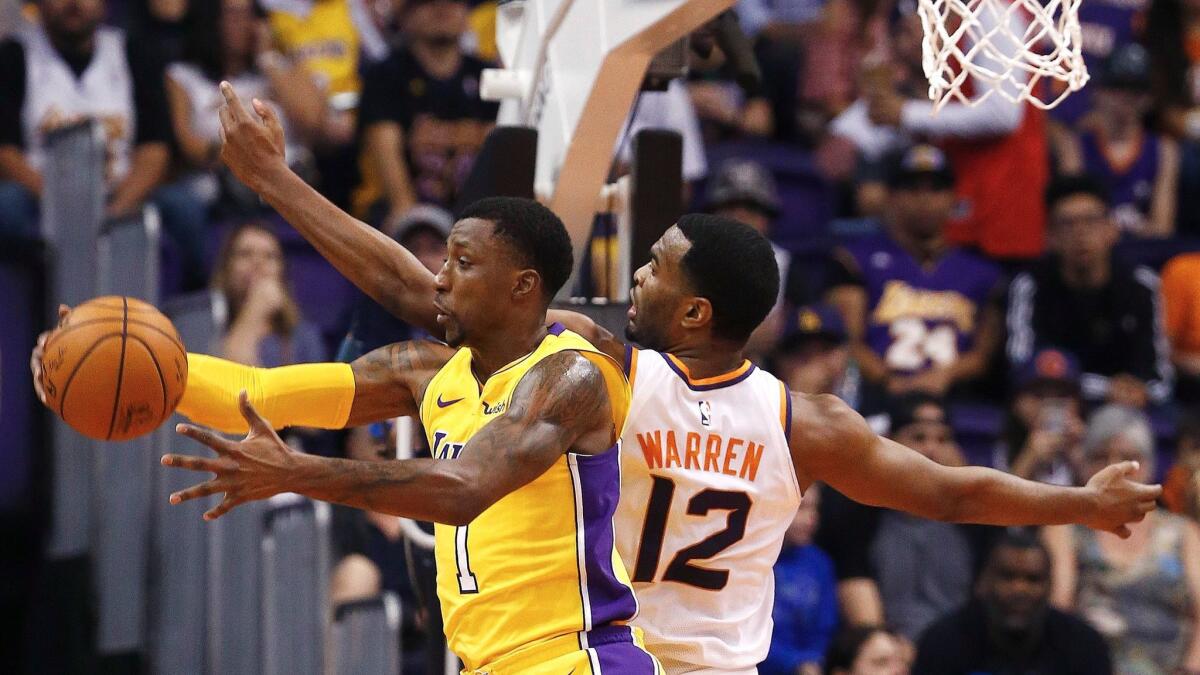 Lakers guard Kentavious Caldwell-Pope grabs the ball away from Phoenix forward T.J. Warren on Nov. 13.