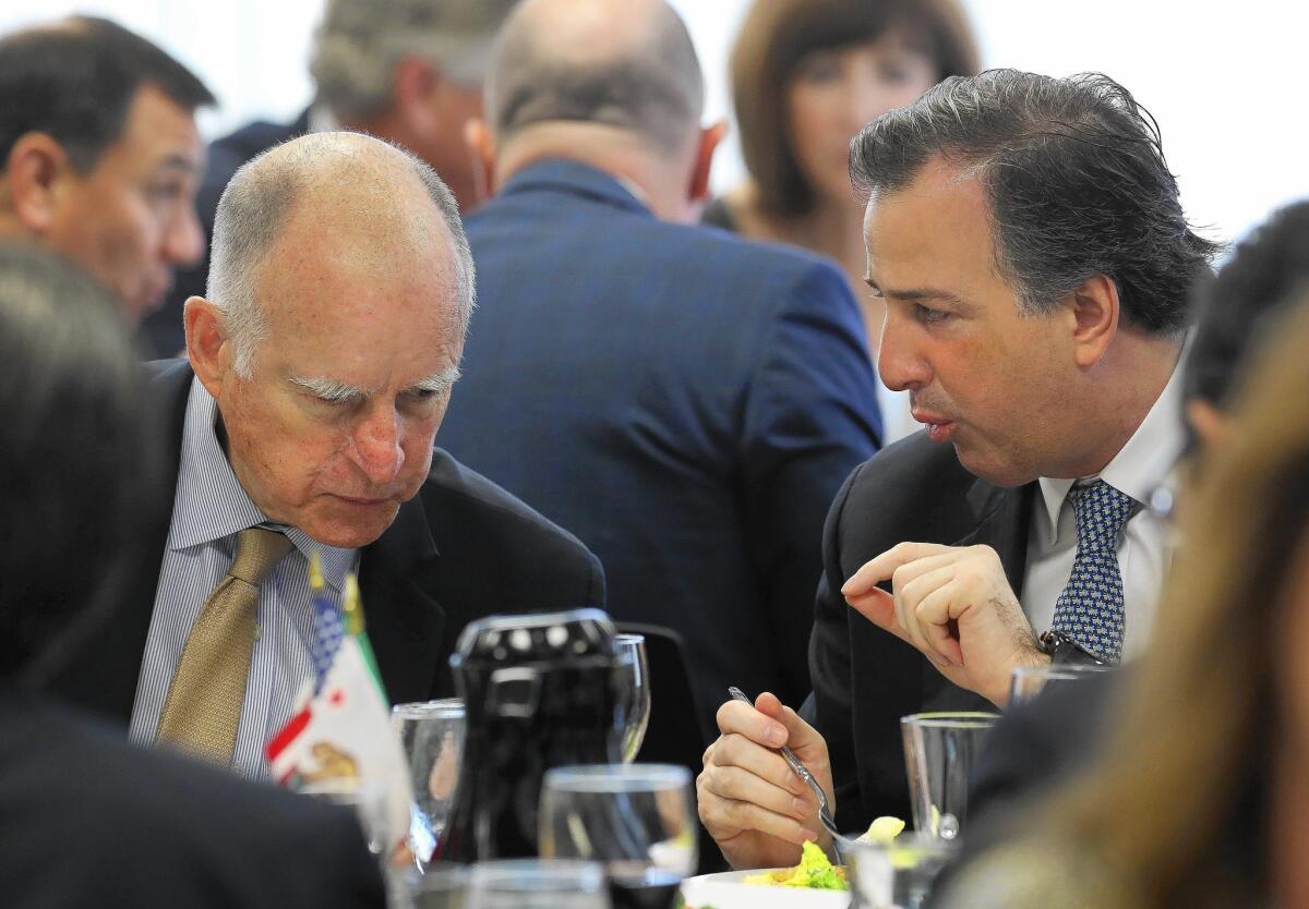 Gov. Jerry Brown, left, and Mexican Secretary of Foreign Affairs Jose Antonio Meade Kuribrena talk during a Chamber of Commerce luncheon in Sacramento. They discussed Brown's impending trip to Mexico.