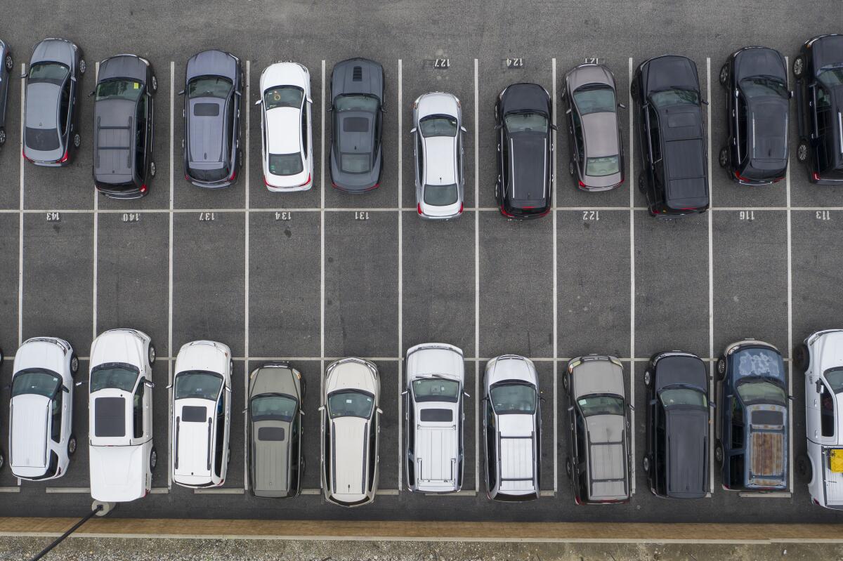 An overhead view of cars parked in a parking lot.