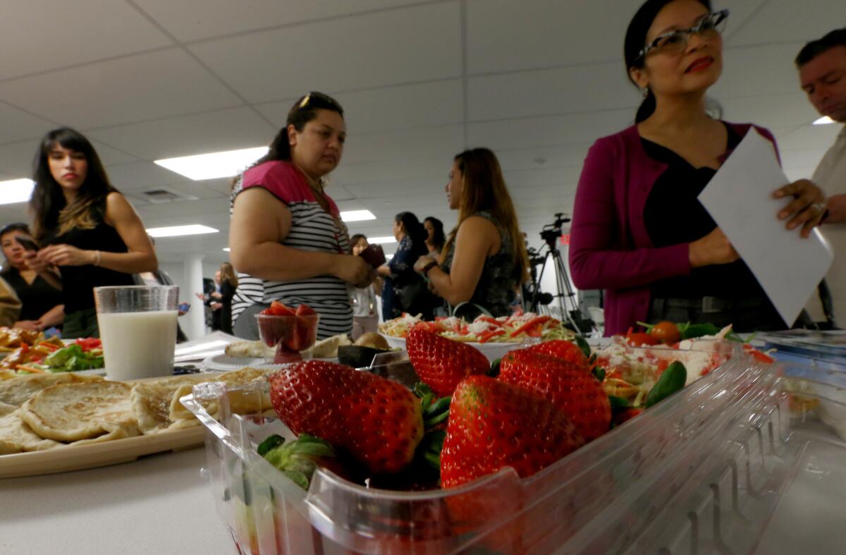 Visitors to L.A. Kitchen look at healthy food options as the L.A. County Department of Public Health launches its "Healthy Eating Out" campaign.