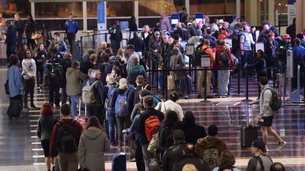 Travelers wait in line to go through the security area at Reagan National Airport on Nov. 21, 2016 in Arlington, Virginia. Heavy air travel is expected for this Thanksgiving holiday and weekend.