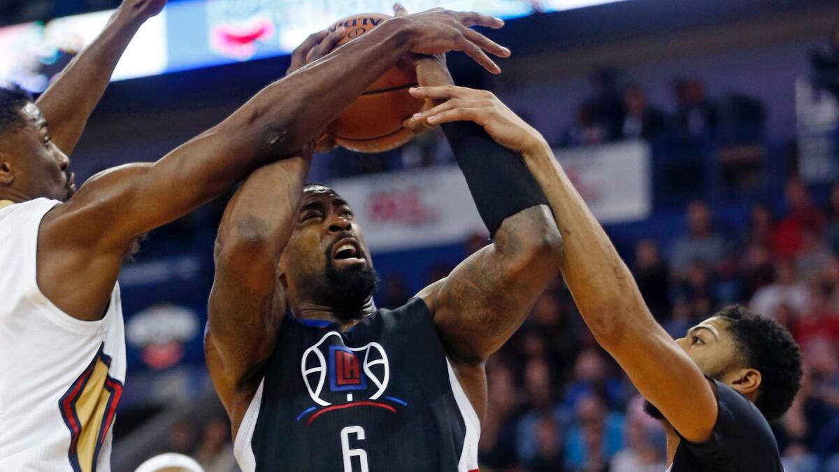 Clippers center DeAndre Jordan (6) is fouled by New Orleans' Anthony Davis, right, as Solomon Hill also defends on Dec. 28.