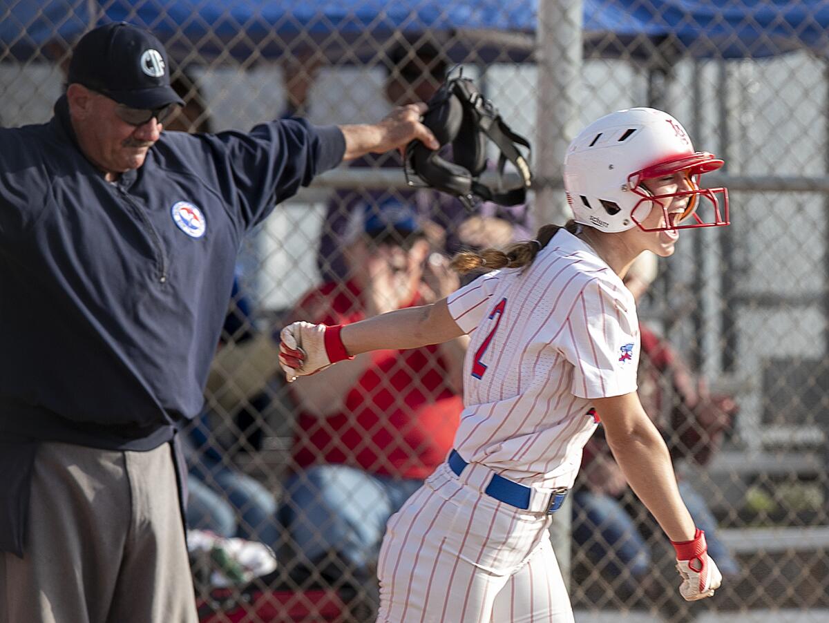 Los Alamitos' Julie Holcomb scores the winning run in the eighth against Huntington Beach on Monday.