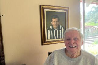 Former NFL referee Jim Tunney sits in front of a portrait of himself in his Pebble Beach home.