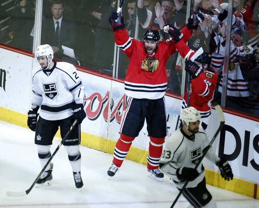 Chicago Blackhawks forward Michal Handzus, center, celebrates after scoring the winning goal in double overtime of the Kings' 5-4 loss in Game 5 of the Western Conference finals on Wednesday.