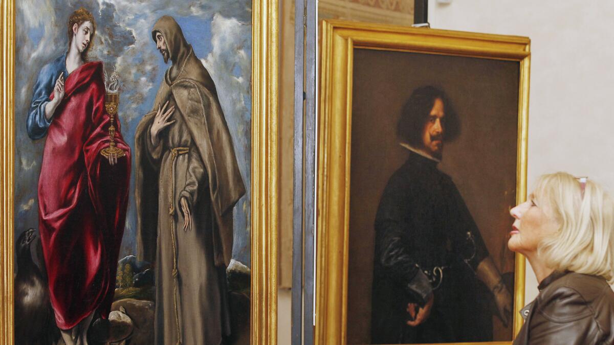A woman admires canvases by El Greco and Diego de Velázquez at the Uffizi Gallery in 2011.