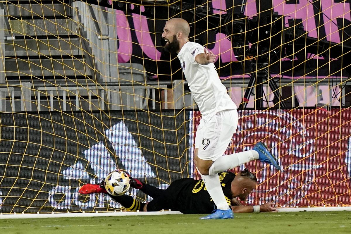 Inter Miami forward Gonzalo Higuain (9) celebrates after scoring a goal as Columbus Crew defender Vito Wormgoor falls to the field during the first half of an MLS soccer match Saturday, Sept. 11, 2021, in Fort Lauderdale, Fla. (AP Photo/Lynne Sladky)