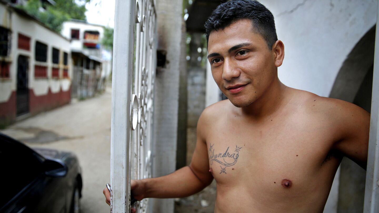 Contreras, 25, at his Honduras home on July 10, 2014. The tatoo "Sandra" is in honor of the sister who raised him there. This year he was deported from San Diego, where he had lived nearly 14 years. He left behind his girlfriend, daughter and son.