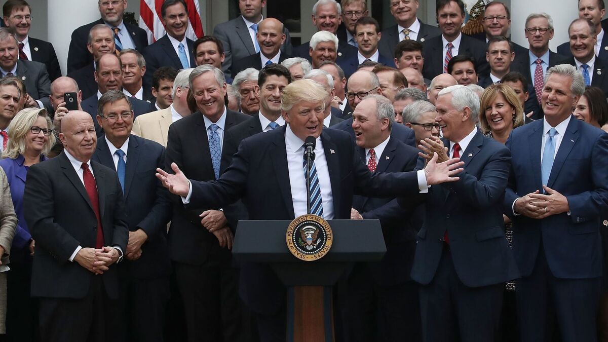 President Trump and the House GOP celebrate passage of Obamacare repeal Thursday. At far right, House Majority Leader Kevin McCarthy, in whose California district more than 70,000 constituents could lose Medicaid coverage under the repeal bill.