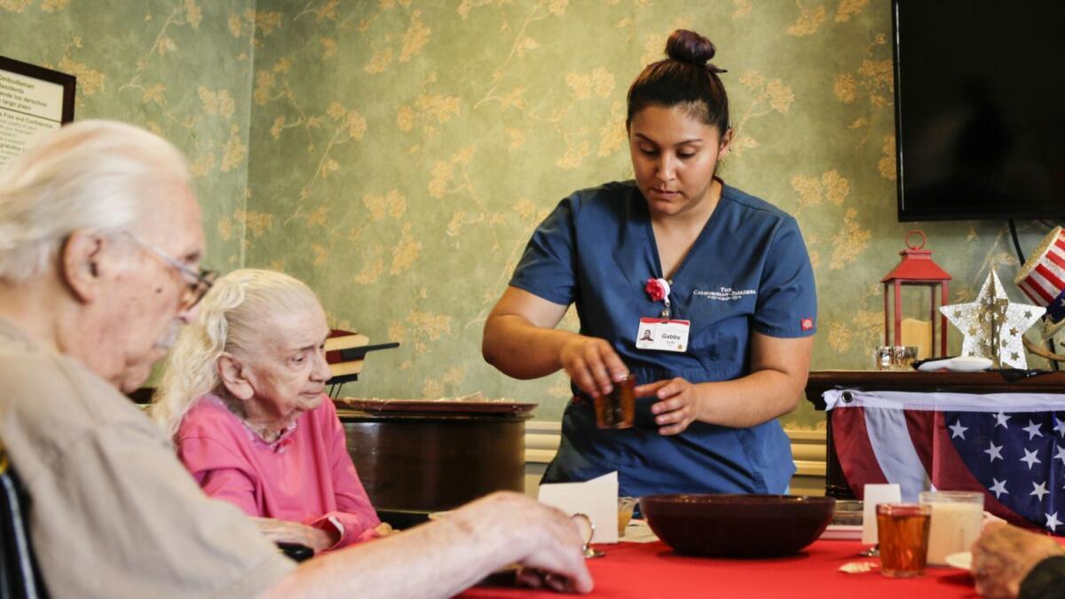 Nursing assistant Gabby Carrillo works at a nursing home in Pasadena. California's healthcare and educational services sector grew 2.9% year over year.