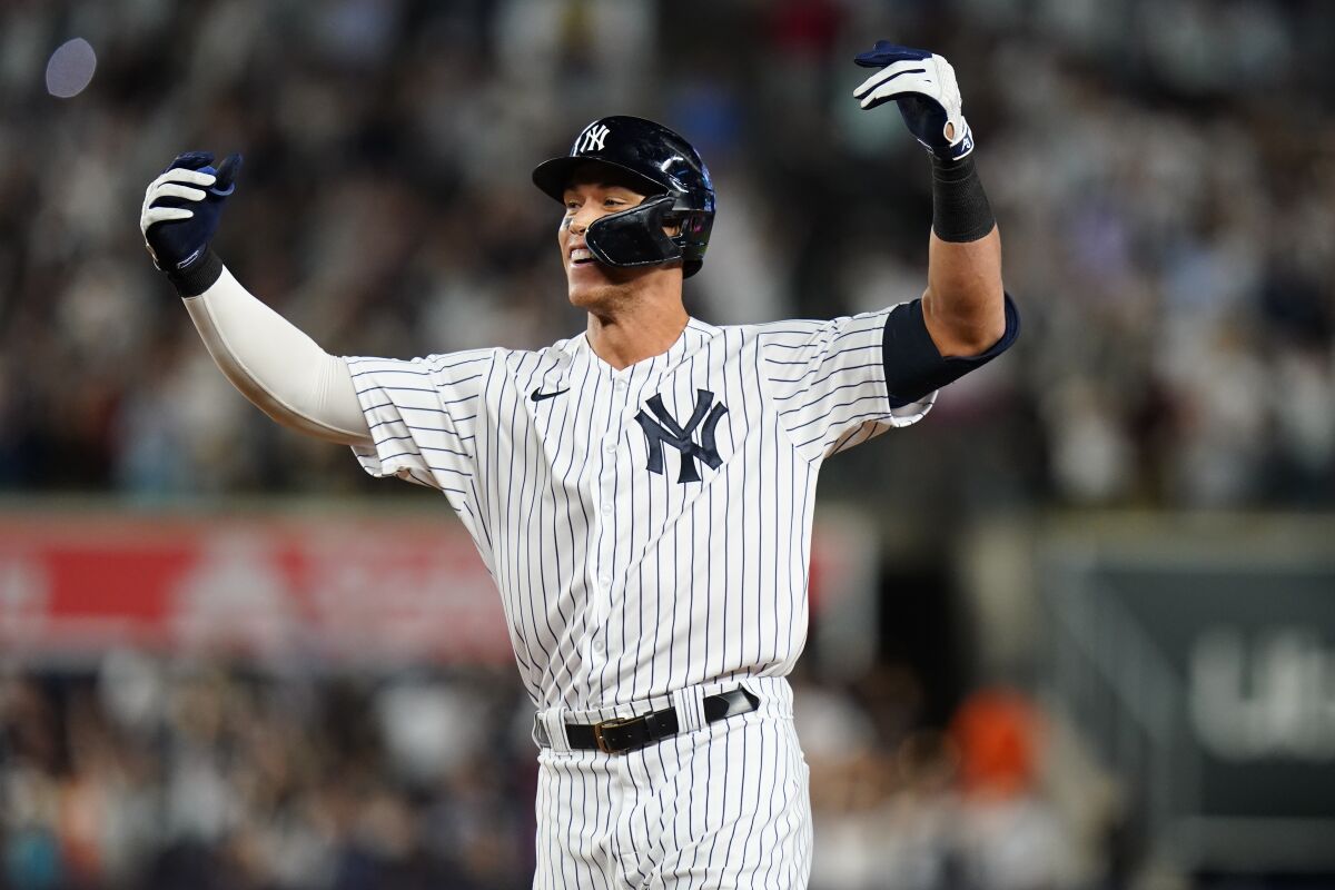 New York Yankees' Aaron Judge gestures to teammates after hitting a single to drive in the winning run during the ninth inning of the team's baseball game against the Houston Astros on Thursday, June 23, 2022, in New York. (AP Photo/Frank Franklin II)