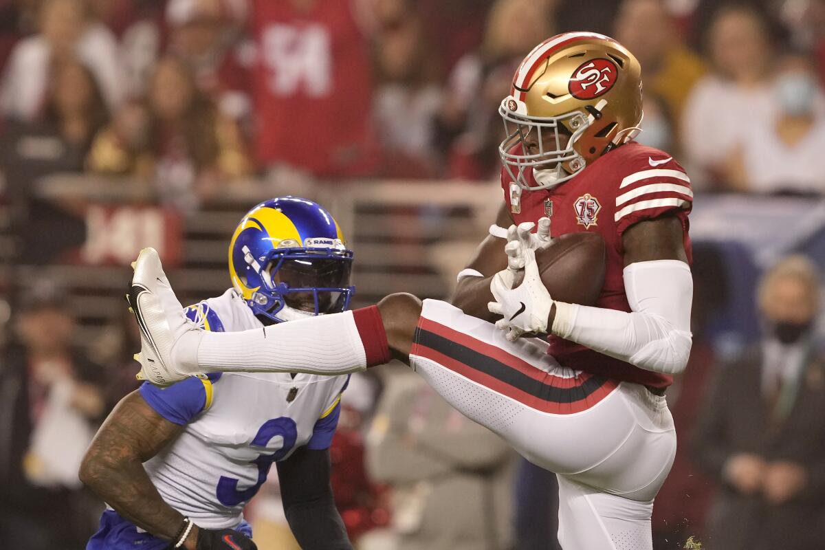 San Francisco 49ers free safety Jimmie Ward, right, intercepts a pass intended for Rams wide receiver Odell Beckham Jr.
