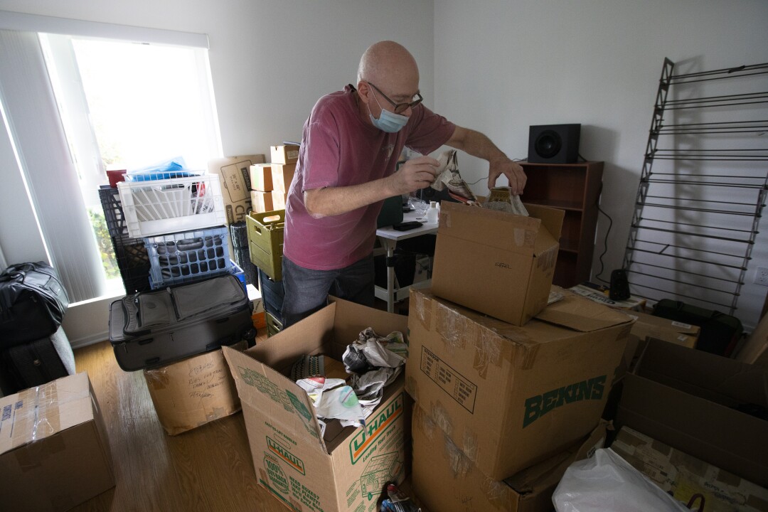 Terrance Whitten unpacks his belongings inside his new apartment in L.A.'s Glassell Park neighborhood.
