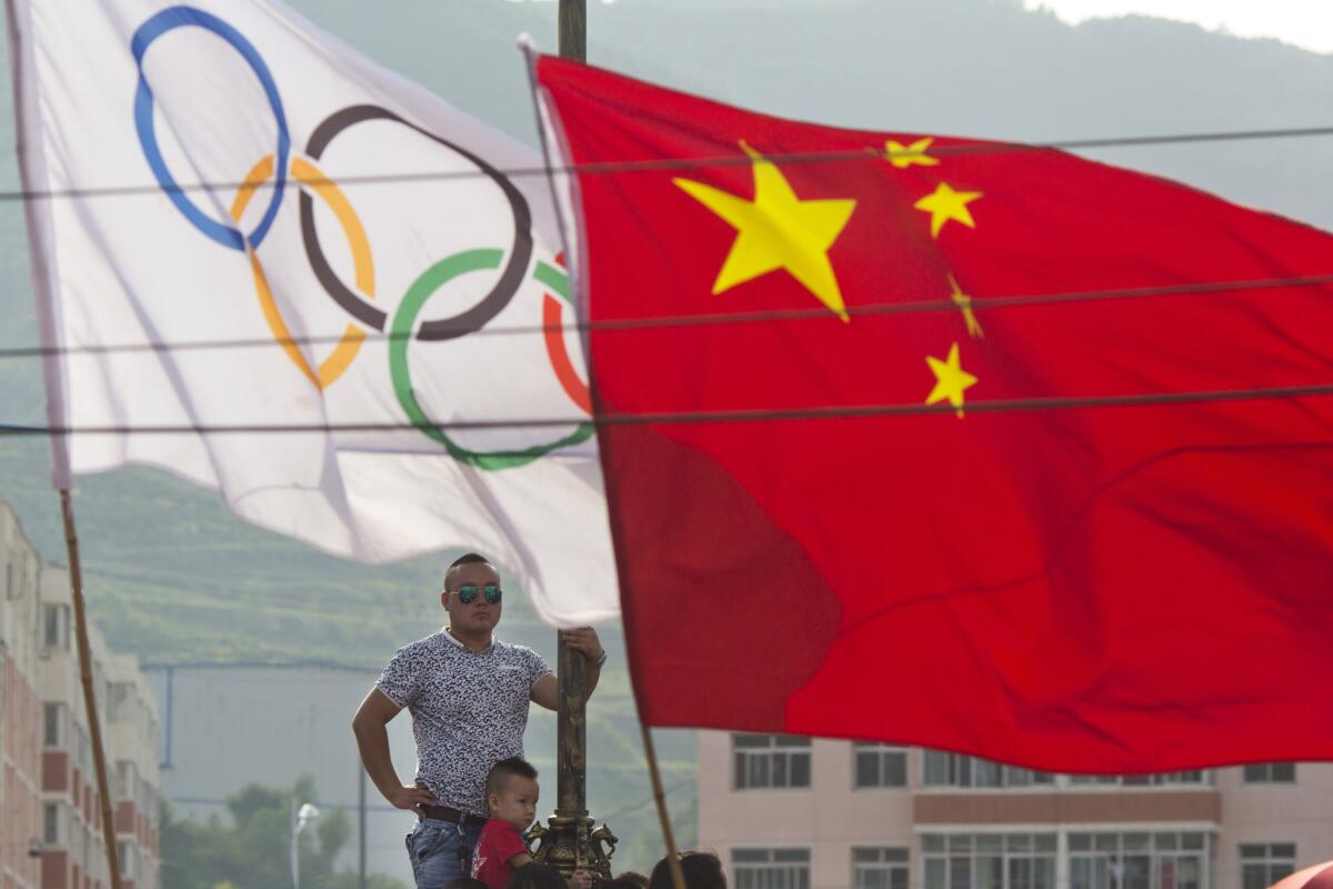 Residents waits for the decision for Beijing to be named the host city for the 2022 Winter Olympics at the ski resort region of Chongli where the Nordic skiing, ski jumping, and other outdoor Olympic events will be held.