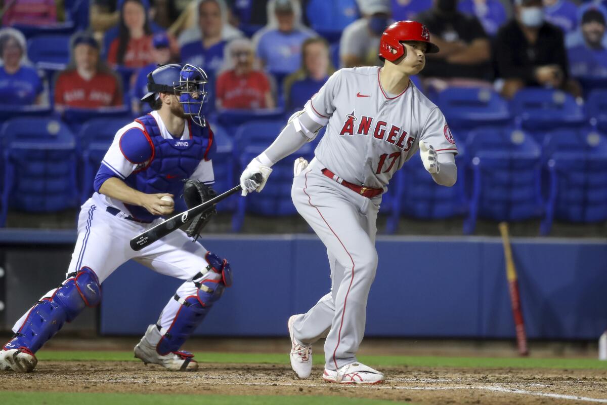 Angels' Shohei Ohtani strikes out in front of Toronto Blue Jays catcher Danny Jansen.