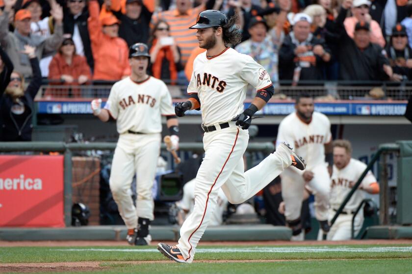 San Francisco's Brandon Crawford scores the winning run of a 5-4 victory over the St. Louis Cardinals in Game 3 of the National League Championship Series on Tuesday.