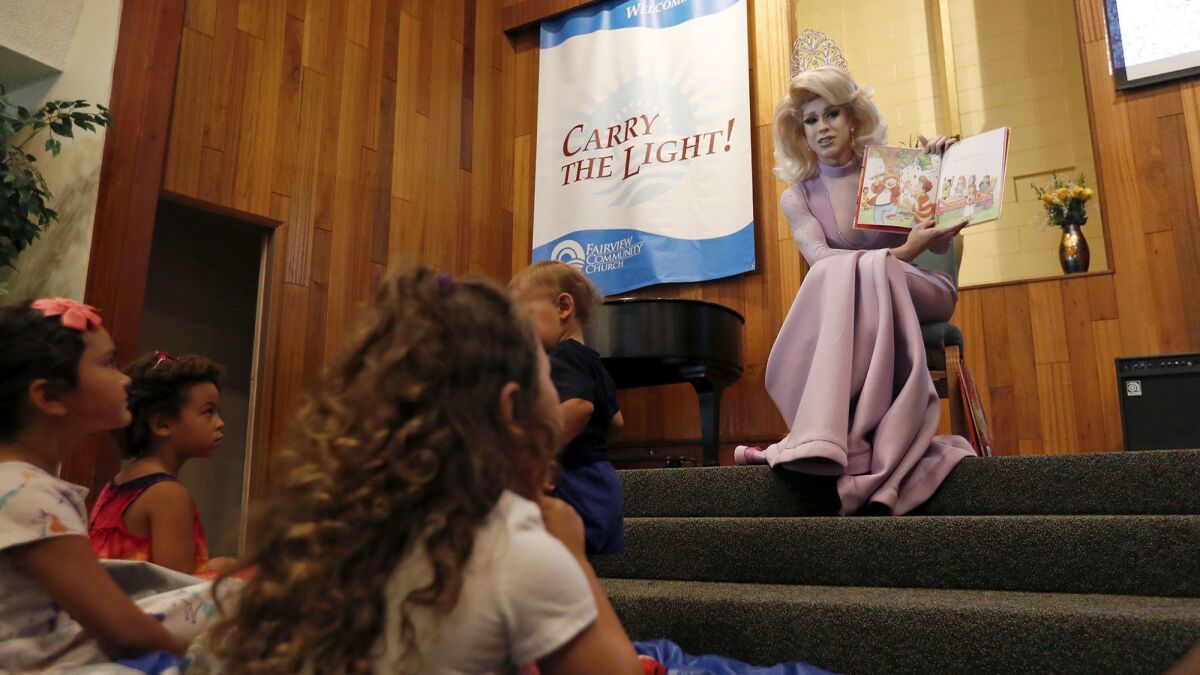 Drag queen Autumn Rose reads to children at Fairview Community Church in Costa Mesa on Wednesday.