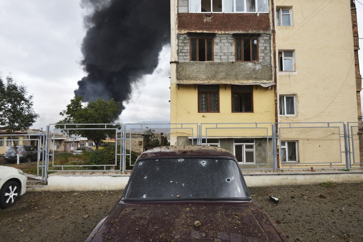 A building burns after shelling by Azerbaijan's artillery during a military conflict in Nagorno-Karabakh early Sunday. 
