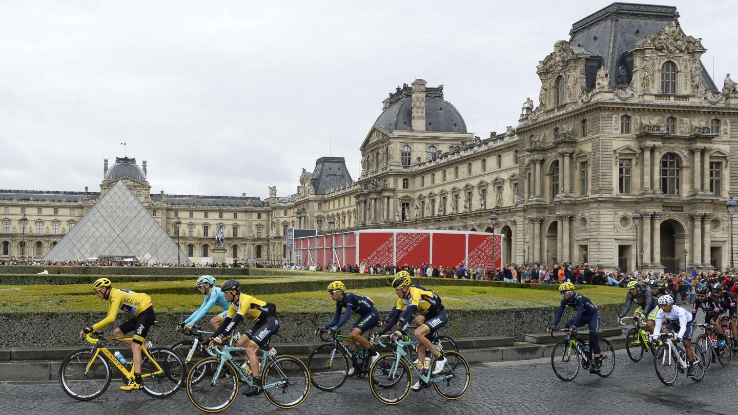 Peloton rides past Louvre Museum