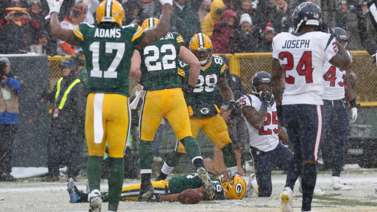 Green Bay's Randall Cobb makes a snow angel after catching a touchdown pass against Houston in 2015.