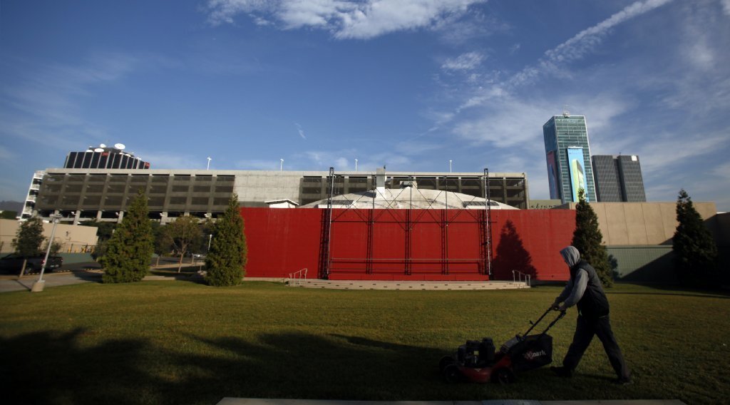 A worker cuts the grass at the Hollywood property that the Academy of Motion Picture Arts and Sciences sold in January after deciding not to build a $400-million movie museum there. Instead, the academy is planning to open a museum on the Los Angeles County Museum of Art campus.