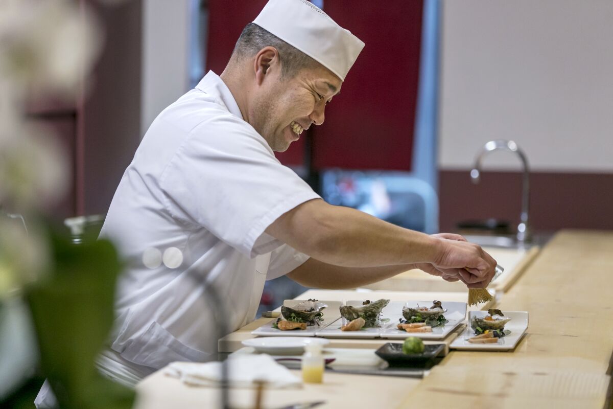 Shin Sushi chef-owner Taketoshi Azumi prepares omasake appetizers.