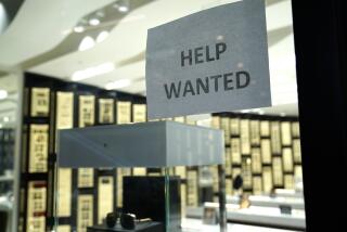 A Help Wanted sign is posted at a Designer Eyes store at Brickell City Centre, Friday, Nov. 6, 2020, in Miami. The number of people applying for unemployment aid jumped last week to 853,000, the most since September, evidence that some companies are cutting more jobs as new virus cases spiral higher. The Labor Department said Thursday, Dec. 10, that the number of applications increased from 716,000 the previous week. (AP Photo/Lynne Sladky)