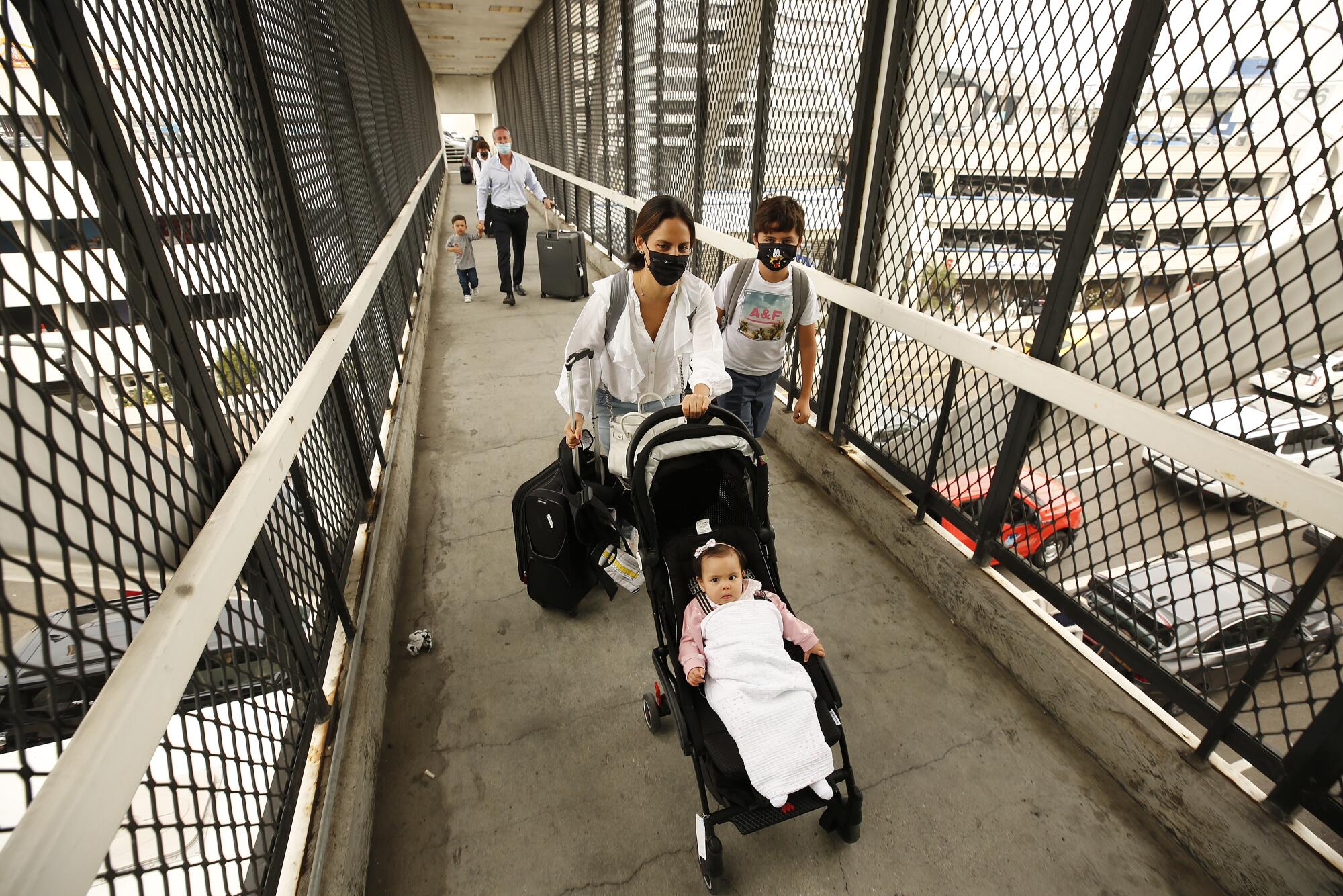 The Campos family make their way to the terminal to fly to Puerto Vallarta