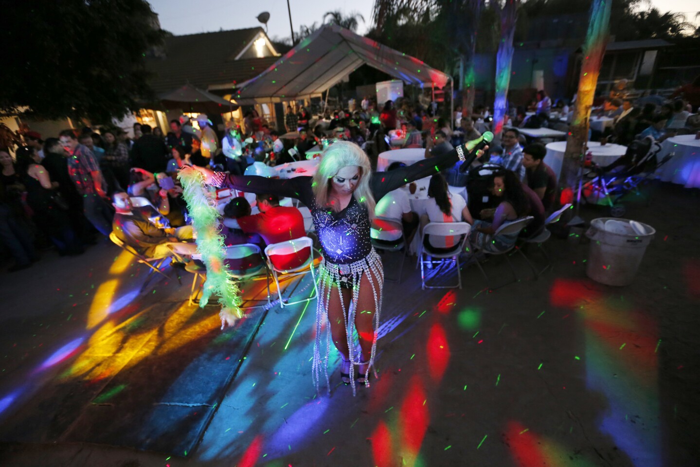 An entertainer sings and dances in a La Puente backyard during a festival reminiscent of those held in Ocotlan, Mexico.