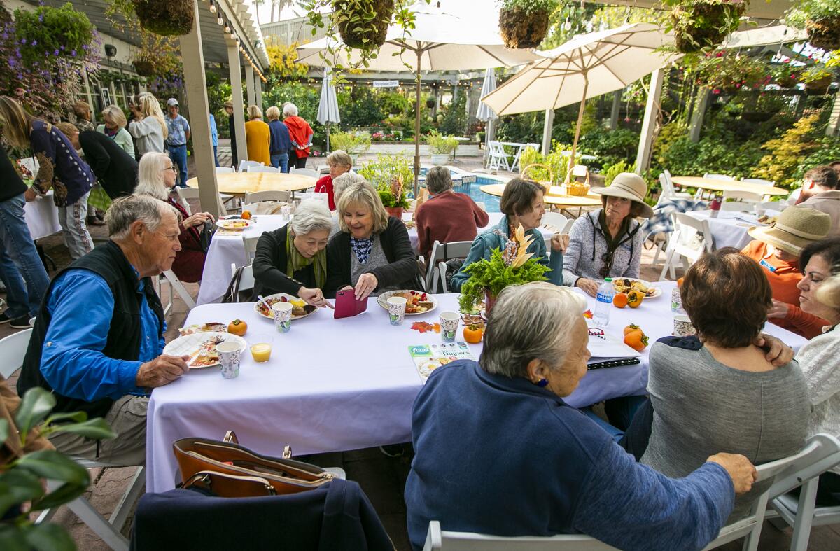 Volunteers of Sherman Library and Gardens gather for a First Monday Coffee meeting on Monday.