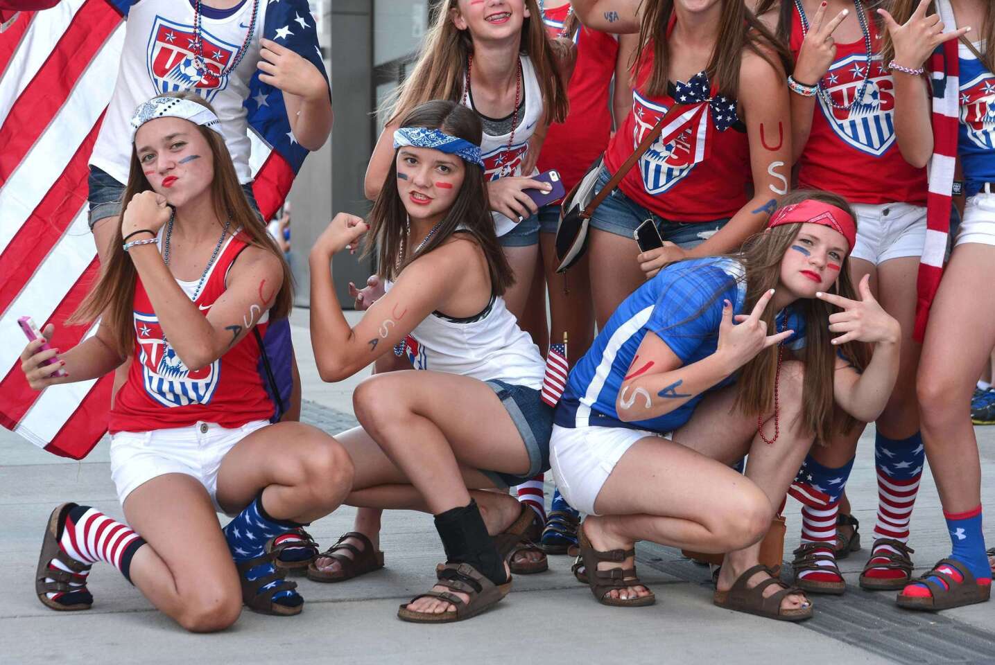 Young USA fans pose before a 2015 FIFA Women's World Cup quarterfinal match against China at Lansdowne Stadium in Ottawa, Ontario on June 26, 2015. AFP PHOTO/NICHOLAS KAMMNICHOLAS KAMM/AFP/Getty Images ** OUTS - ELSENT, FPG - OUTS * NM, PH, VA if sourced by CT, LA or MoD **