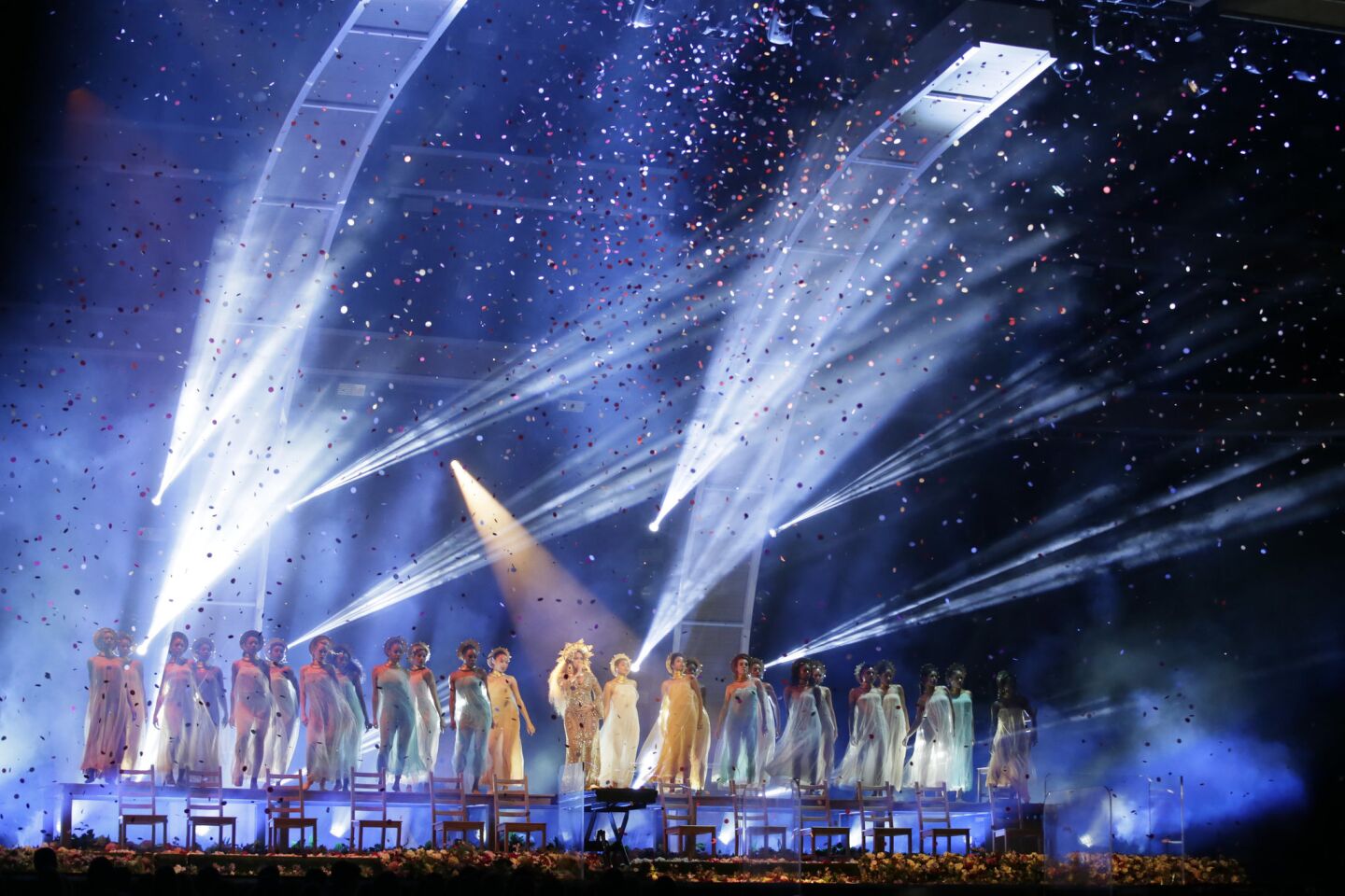 Spotlights set the mood as Beyoncé performs onstage at the Grammys.