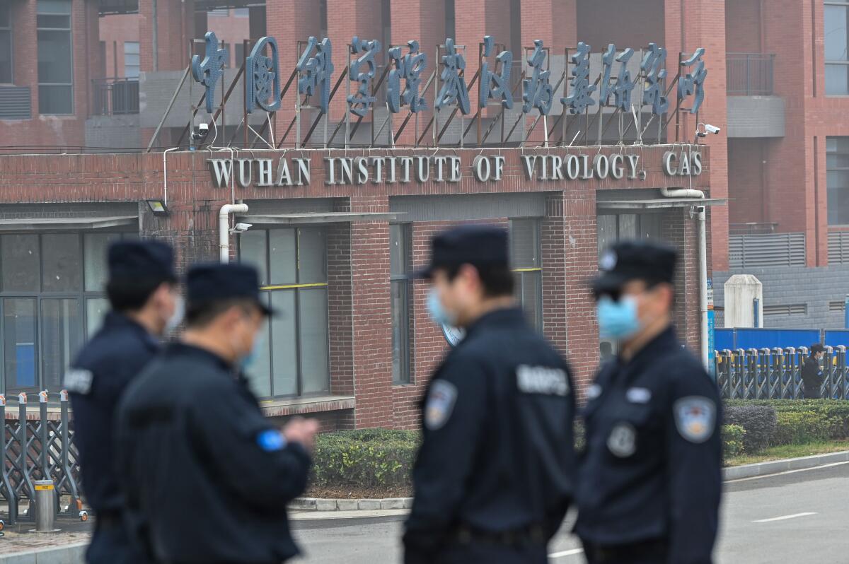 Security personnel stand guard outside the Wuhan Institute of Virology in China.