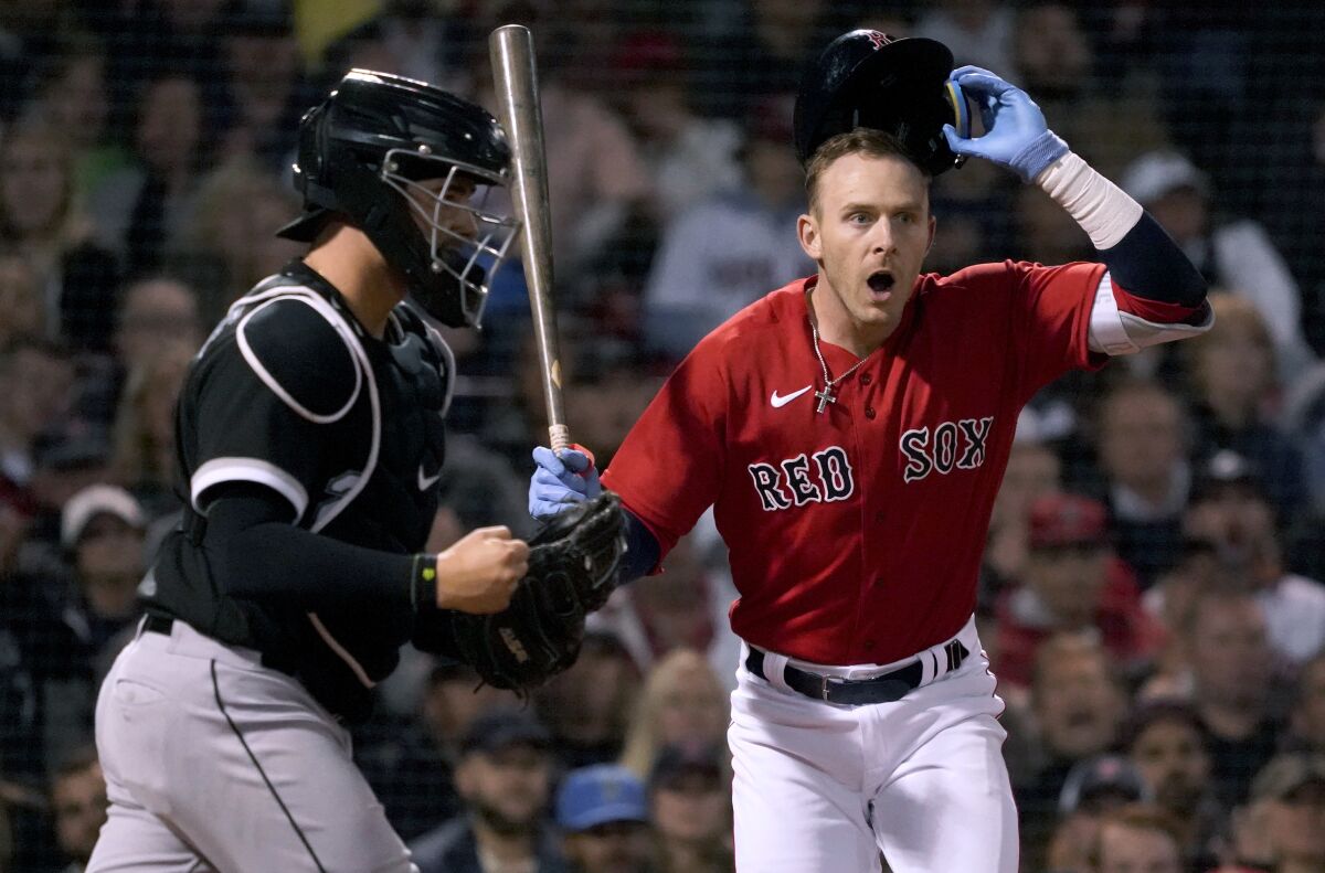 Boston Red Sox's Trevor Story reacts after being called out on strikes, next to Chicago White Sox catcher Reese McGuire (21) during the fifth inning of a baseball game at Fenway Park, Friday, May 6, 2022, in Boston. (AP Photo/Mary Schwalm)