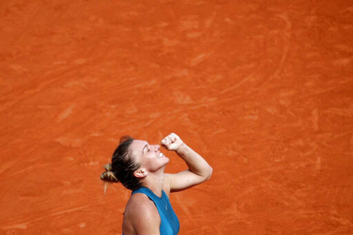 FILE - In this June 9, 2018, file photo, Romania's Simona Halep clenches her fist after defeating Sloane Stephens of the United States during the women's singles final of the French Open tennis tournament at Roland Garros stadium in Paris. (AP Photo/Christophe Ena, File)