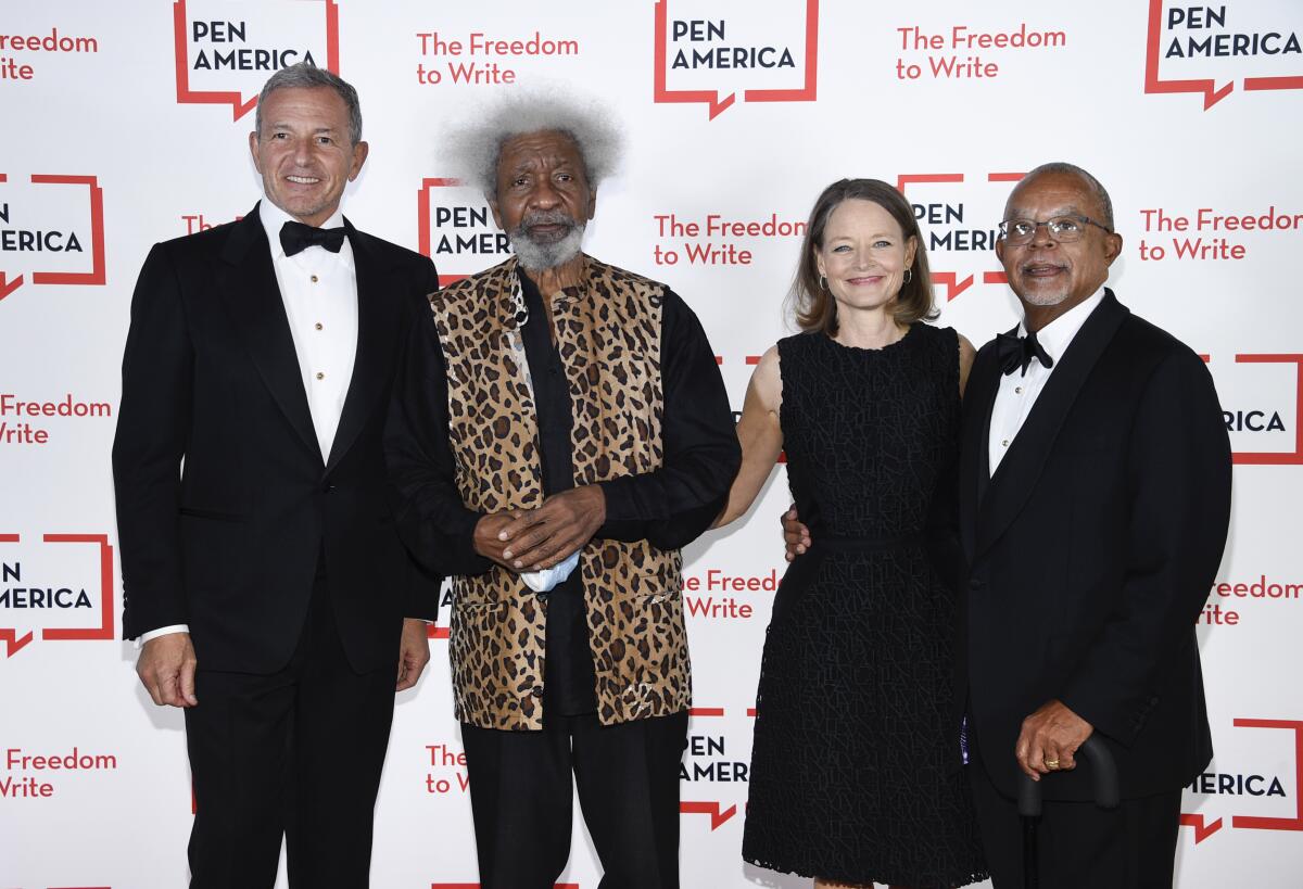 Corporate honoree Robert Iger, left, playwright Wole Soyinka, actress Jodie Foster and PEN/Audible Literary Service Award recipient Dr. Henry Louis Gates pose together at the 2021 PEN America Literary Gala at the American Museum of Natural History on Tuesday, Oct. 5, 2021, in New York. (Photo by Evan Agostini/Invision/AP)