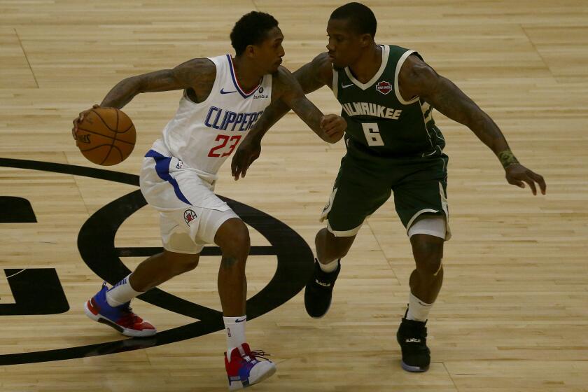 LOS ANGELES, CALIF. - NOV. 6, 2019. Clippers guard Lou Williams works to the basket against Bucks guard Eric Bledsoe in the first quarter at Staples Center in Los Angeles on Wednesday night, Nov. 6, 2019. (Luis Sinco/Los Angeles Times)