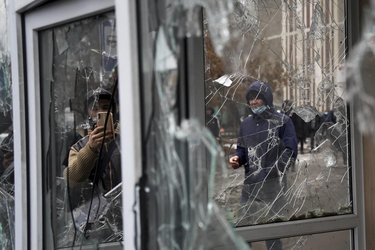 Broken windows of a police kiosk